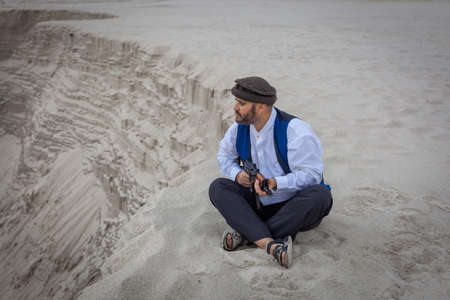 A  soldier monitors a road in Afghanistan. A soldier stands on guard with a weapon to kill.の写真素材