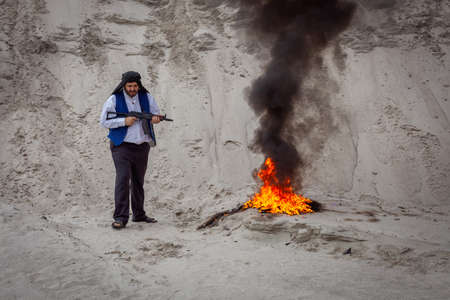 Afghan terrorists are destroying them with fire.  are intimidating people with weapons in their hands. Insurgent fighters are a terrorist guerrilla organization.の写真素材