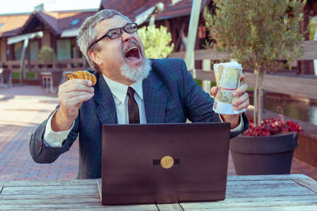 Male businessman trader shows stop with his hand and demonstrates bitcoin.の写真素材