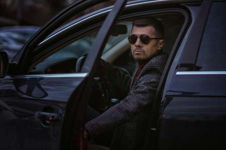 Business portrait of a man in a car. Fashionable prestigious guy.の写真素材