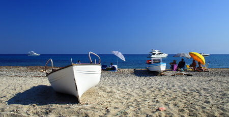 white boats and people on the beachの写真素材
