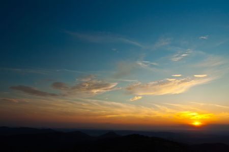 colorful sunset with blach hillsの写真素材