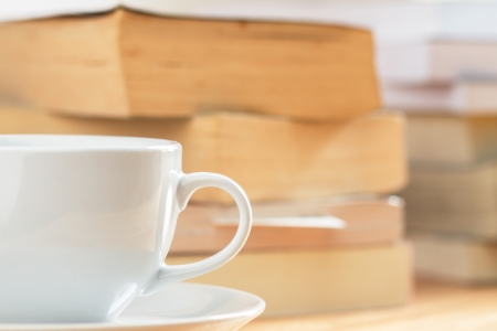 coffee cup with pile of book の写真素材