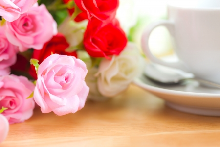 artificial roses on wooden deskの写真素材