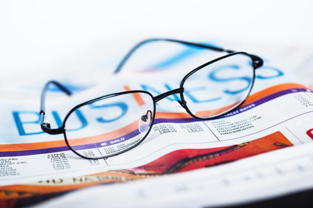 eyeglasses on newspaper close up