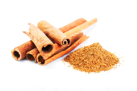 cinnamon sticks and powder close up on white background