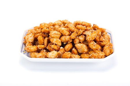 crispy peanut with sesame in plate on white backgroundの写真素材