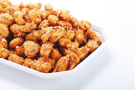 crispy peanut with sesame in plate on white backgroundの写真素材