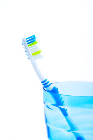 toothbrush in blue plastic glassの写真素材