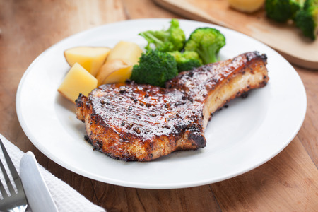 pork chop with vegetable in plateの写真素材