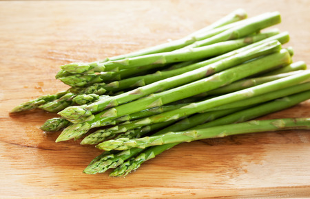 asparagus prepare for cooking on chopping blockの写真素材