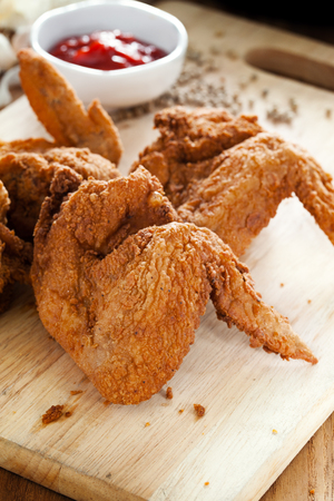 fried chicken wings on wooden boardの写真素材