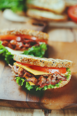 grilled bacon sandwich  on wooden boardの写真素材