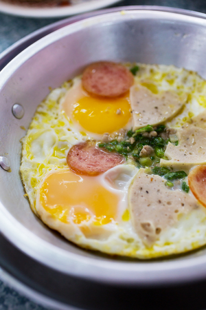 fried eggs with preserved pork sausage for breakfastの写真素材