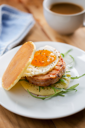 pancak with grilled ham and fried egg sandwich for breakfastの写真素材
