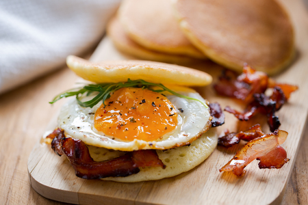 pancake with fried egg and bacon sandwichの写真素材