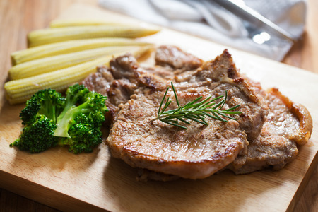 grilled pork chop with broccoli and baby cornの写真素材