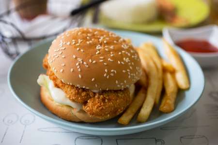fried chicken burgerand french fries for meal in restaurantの写真素材