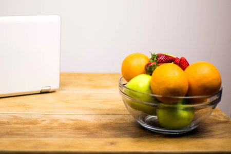fruit and laptop on daskの写真素材