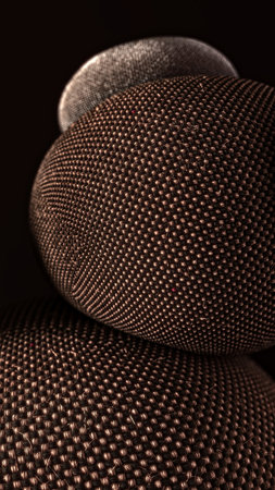 Close-up of stacked textile-covered spheres with detailed woven surface textureの写真素材