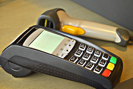 Bank terminal with hand reader of barcodeの写真素材