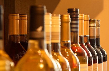 Wine bottles on wooden shelf in wine storeの写真素材