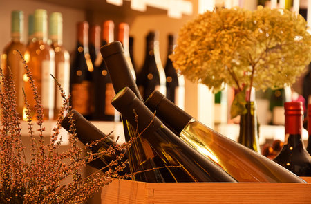 Wine bottles on wooden shelf in wine store