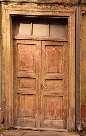 Closed vintage wooden door in old buildingの写真素材