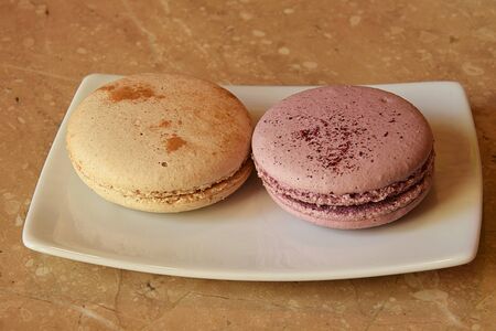 Multi colored macarons biscuits close-up on plateの写真素材