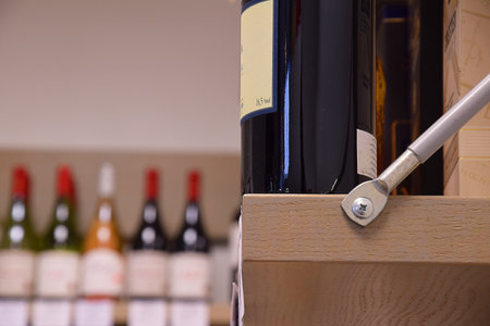 Wine bottles on wooden shelf in wine storeの写真素材