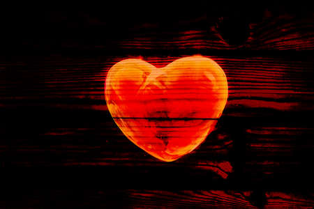Abstract red hart on black background, wallpaper.の写真素材