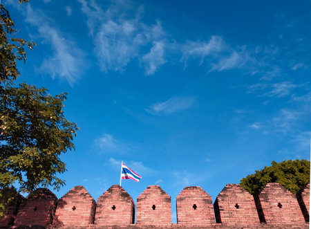 blue sky and brick wall and thailand flag