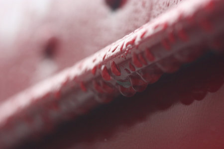 rain drop on the red metal wall selective focus