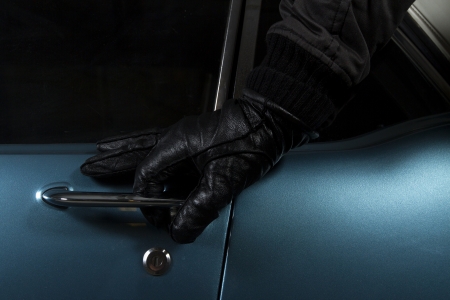 man trying to steal blue carの写真素材