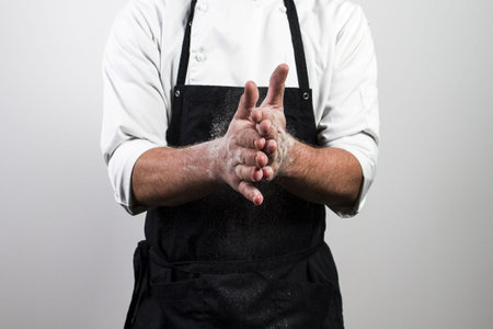 chef with flour on handsの写真素材
