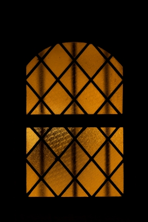 old church window brightly litの写真素材