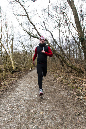 A man running outdoors in a forestの写真素材