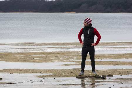 A man jogging at the sea at winterの写真素材
