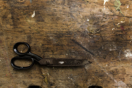 rusty old scissors on wooden backgroundの写真素材