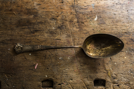 old silver spoon on wood backgroundの写真素材