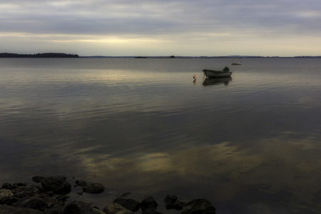Small fishing boat anchored in Denmarkの写真素材