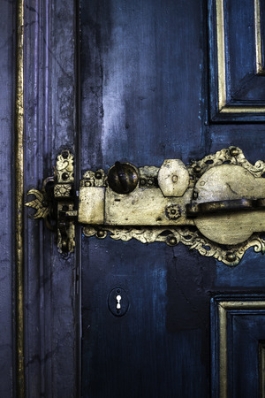 ancient gold door lock on blue doorの写真素材
