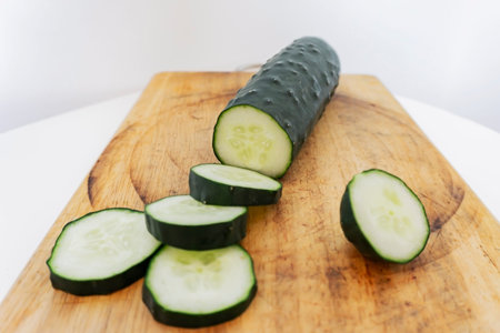 cucumber isolated on wood tableの写真素材