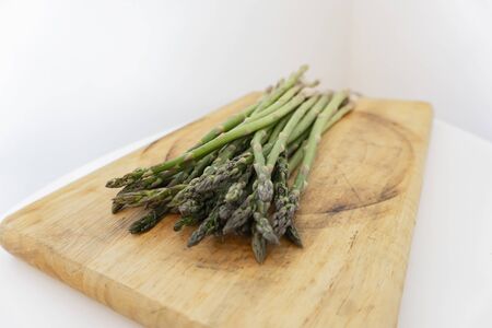 green asparagus isolated on wood tableの写真素材