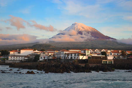 The highest mountain of Portugal, the Azores volcano Montanha do Pico on the island of Pico at sunset, village Madalenaの写真素材