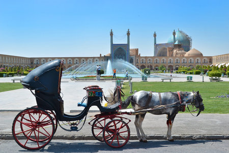 Isfahan, Iran - June 14, 2014: Historic Naqsh-i Jahan Square with fountains and iconic surrounding...