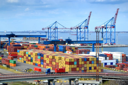 Odessa, Ukraine - April 19, 2019: Cargo port with different ships at pier, driveway, trucks arriving in port. Loading and unloading of ships.のeditorial素材
