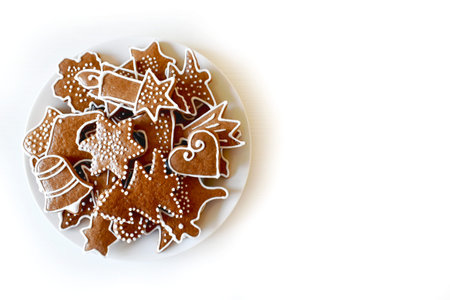 Christmas homemade gingerbread on a plate, handmade, various molds, top view on a white wooden...
