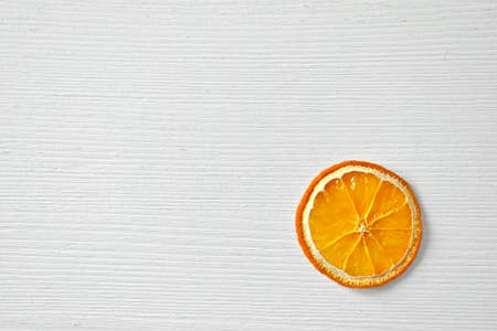 Dried orange orange slice, top view, white background, wood texture, free space for text.の写真素材