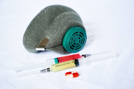 medical respirator, antiviral tablets and 2 syringes with red and yellow liquidsの写真素材
